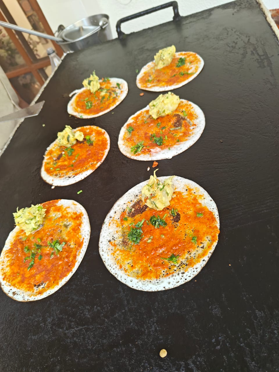 Dosas being prepared at a live catering station