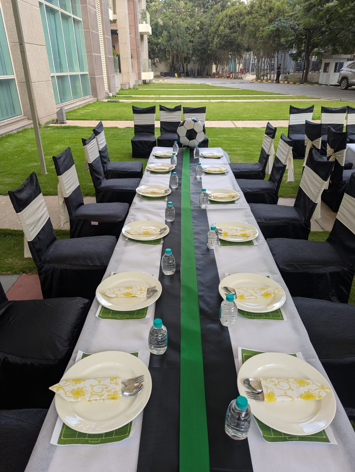 A long outdoor dining table prepared for guests